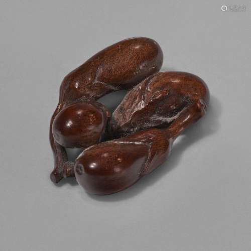 A CARVED WOOD SCULPTURE (NETSUKE) OF EGGPLANTSTAISHO-SHOWA P...