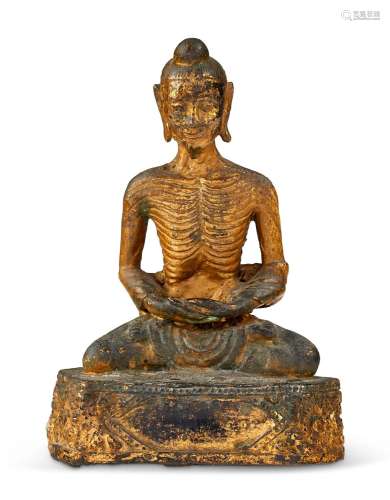 A GILT-LACQUERED BRONZE FIGURE OF EMACIATED SIDDHARTHA THAIL...