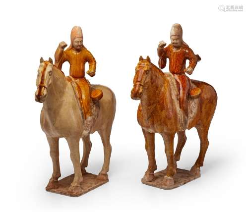 A PAIR OF AMBER-GLAZED POTTERY FIGURES OF EQUESTRIANS  TANG ...