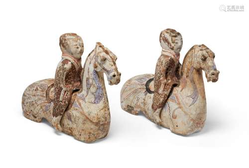 A PAIR OF PAINTED POTTERY FIGURES OF EQUESTRIANS  HAN DYNAST...