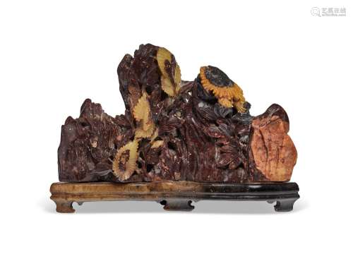 A BLACKISH-BROWN AND YELLOW SOAPSTONE MOUNTAIN-FORM BRUSH RE...