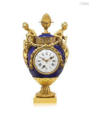 A LOUIS XVI ORMOLU-MOUNTED SEVRES BLEU DU ROI PORCELAIN CLOC...