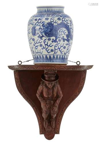 A CONTINENTAL CARVED PINE BRACKET WITH A CHINESE VASE