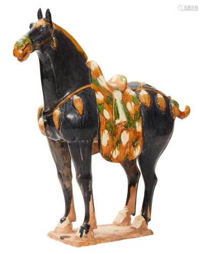 A CHINESE SANCAI POTTERY FIGURE OF A CAPARISONED HORSE