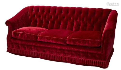 A CRIMSON VELVET THREE-SEATER SOFA