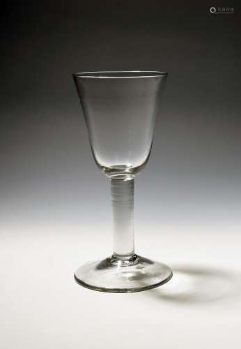 A large glass goblet c.1750, the generous round funnel bowl ...