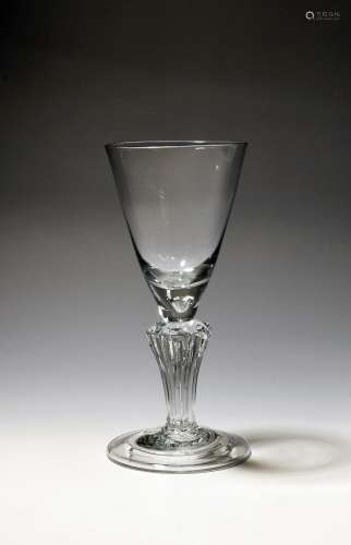 A large wine glass or goblet c.1735, the rounded funnel bowl...