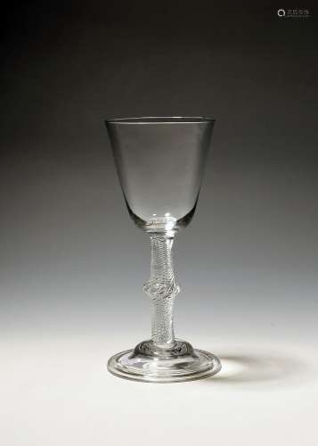 A large wine glass c.1750, the rounded funnel bowl raised on...
