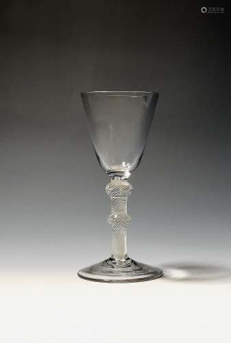A wine glass c.1765, the rounded funnel bowl raised on a dou...