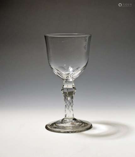 A glass goblet c.1770, the rounded bowl cut with seven petal...