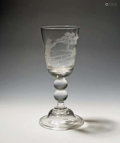 A glass goblet 19th century, the deep rounded funnel bowl en...