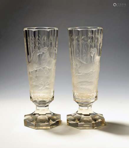A pair of tall Bohemian glass goblets dated 1886, the slight...