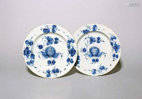 A pair of delftware plates c.1770-80, painted in blue with f...