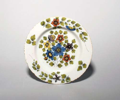 A delftware plate c.1750-60, probably Dublin, well painted i...