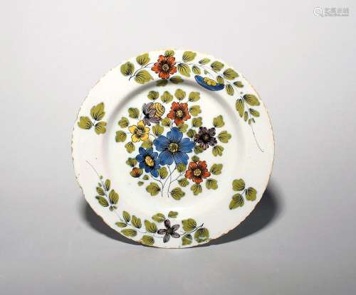 A delftware plate c.1750-60, probably Dublin, well painted i...