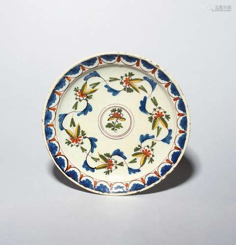 A Vauxhall delftware plate c.1720-30, the shallow dished for...