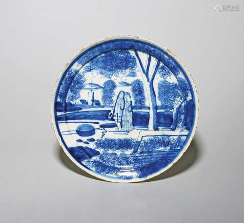 A delftware plate or shallow dish c.1720-30, painted in blue...