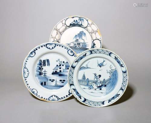 Three delftware plates c.1730-50, one painted with a bird di...