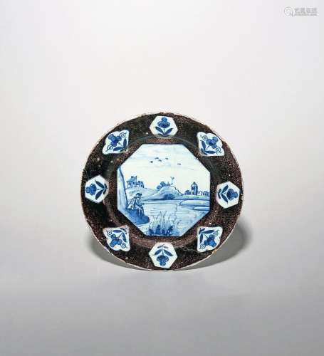 A Lambeth delftware plate c.1720, painted in blue with an oc...