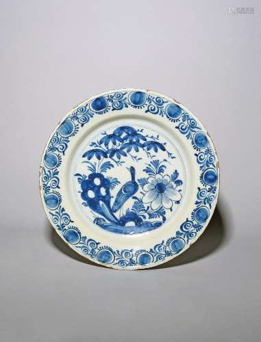 A Delft charger mid 18th century, painted in blue with an aq...
