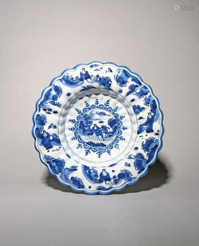 A Delft lobed dish c.1690-1700, painted in blue with a seate...