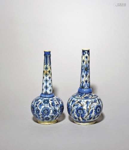 Two Qajar pottery bottles 19th/20th century, with long taper...