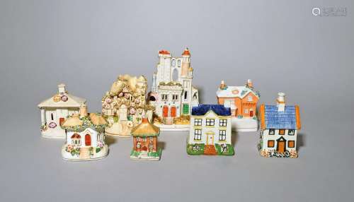 A Pratt ware money box and seven Staffordshire cottages 19th...