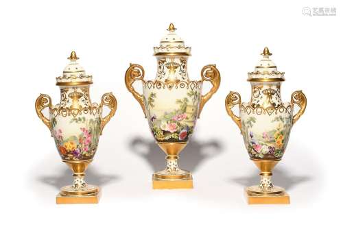 A garniture of three Paris porcelain vases and covers 19th c...