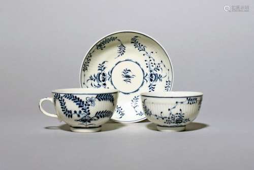 A Lowestoft blue and white teabowl and saucer and a rare tea...