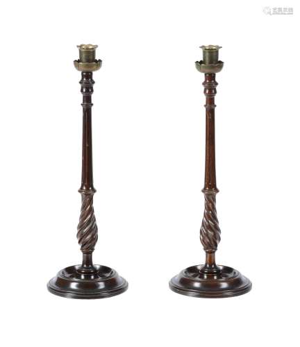 A PAIR OF MAHOGANY AND BRASS MOUNTED TABLE CANDLESTICKS IN S...
