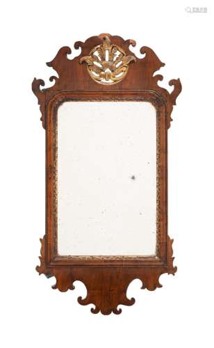 A GEORGE II WALNUT AND PARCEL GILT WALL MIRROR