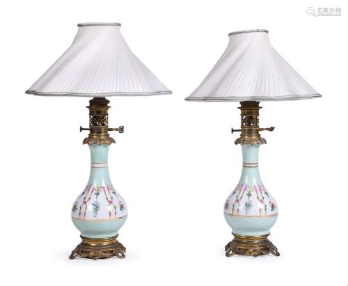 A PAIR OF FRENCH PORCELAIN AND GILT METAL MOUNTED TABLE LAMP...