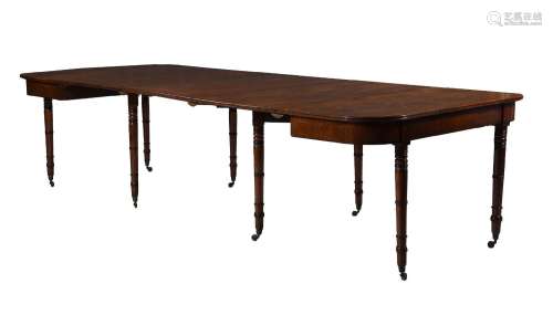 A REGENCY MAHOGANY AND PARCEL EBONISED EXTENDING DINING TABL...