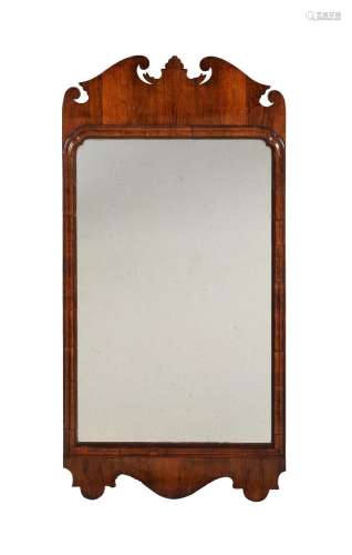 A GEORGE II WALNUT AND FRETWORK WALL MIRROR