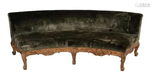 A CURVED GILTWOOD AND UPHOLSTERED SOFA IN MID 18TH CENTURY S...