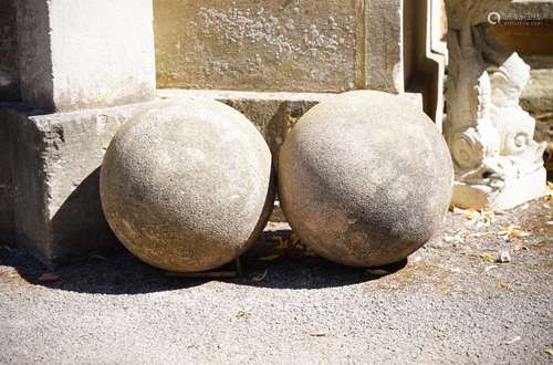 A PAIR OF COMPOSITION STONE SPHERES