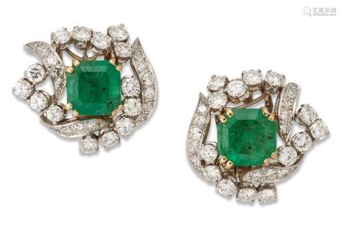 A pair of emerald and diamond ear clips, each of scroll desi...