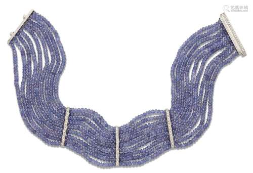 A tanzanite and diamond collar, designed as nine rows of fac...