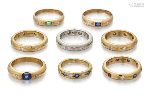 A group of eight gem-set and diamond band rings, including t...