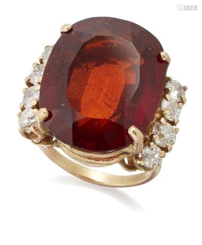 A hessonite garnet and diamond ring, designed as a claw-set ...