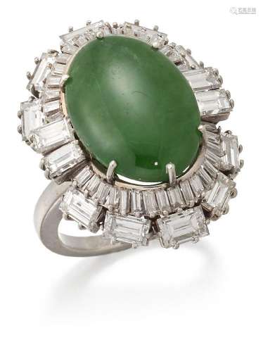 A jade and diamond cluster ring, the oval cabochon jadeite j...
