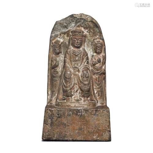 A limestone stele of a Buddhist triad, Northern Zhou dynasty...