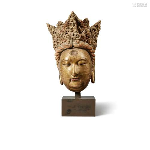 A polychrome-painted and gilt-lacquered stucco head of a bod...