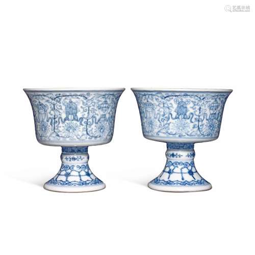 A pair of blue and white 'Eight Buddhist Emblems' stem cups,...