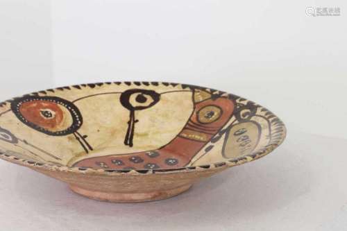 A shallow pottery bowl,