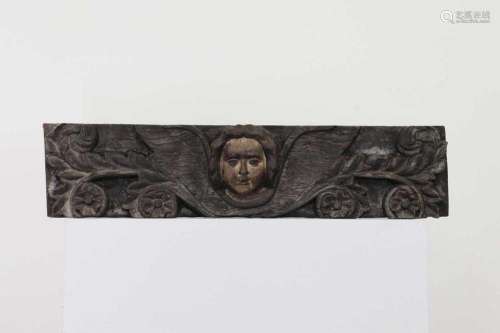 A carved oak and polychrome painted fragment,