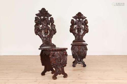 A pair of walnut sgabello hall chairs,