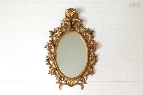 A carved giltwood mirror in the Florentine style,