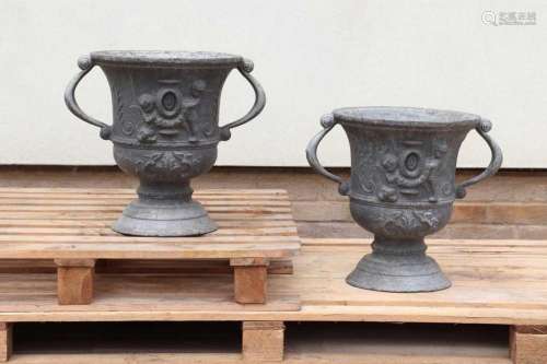 A pair of twin-handled lead urns,