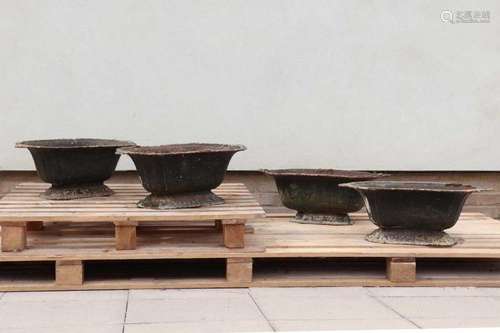 Four cast iron planters,